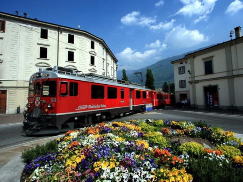 A guide with the train, St. Moritz and Bernina